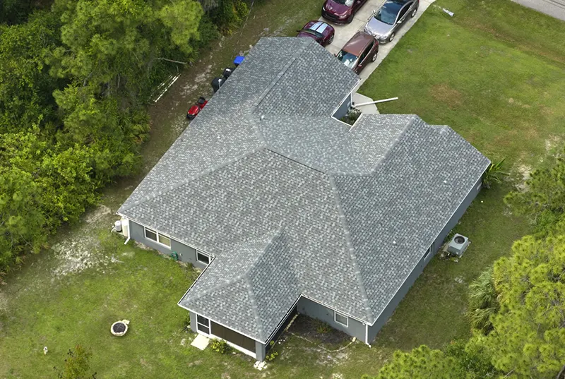 Aerial view of a newly completed roof installation on a modern home, showcasing expert craftsmanship by a Central Florida roofing company and roofing contractor specializing in new roof installation services for residential properties.