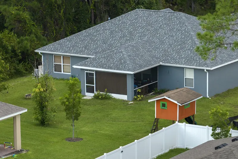 A well-maintained home featuring a newly completed shingle roof replacement by a Central Florida roofing company and expert roofing contractors, providing affordable and reliable roofing solutions.