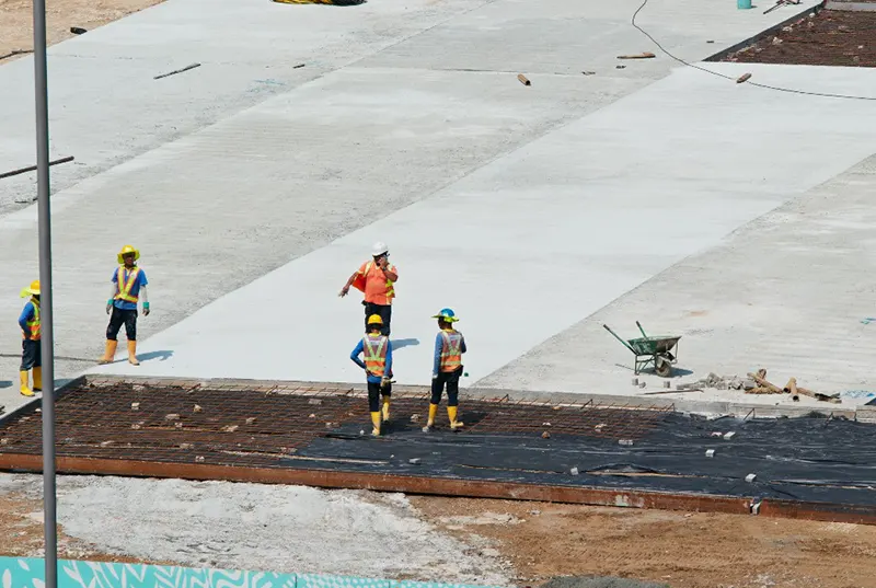 A team of professional roofing contractors from a Central Florida roofing company providing waterproofing services on a large surface, ensuring long-lasting protection for residential roofing and other structures