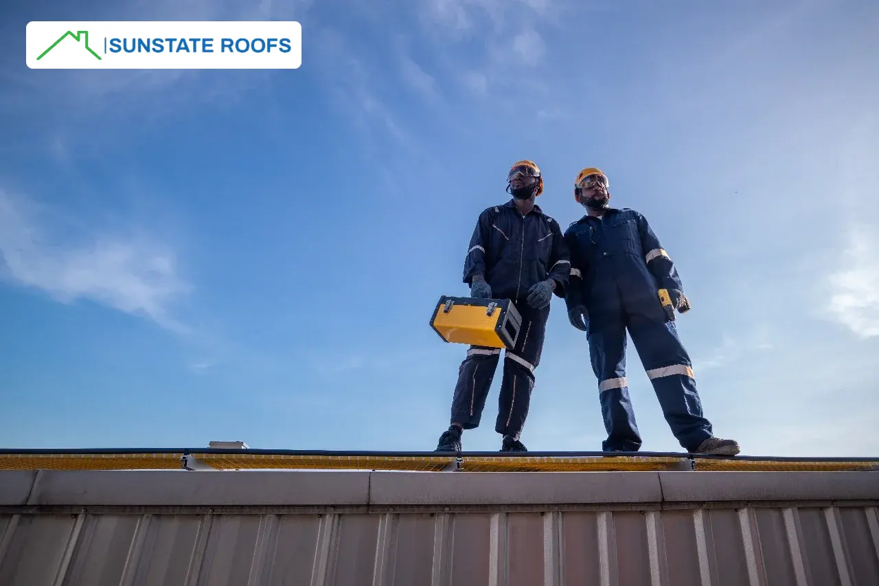 Two roofing professionals standing on a flat roof in Central Florida, equipped with tools for roof waterproofing. The image showcases waterproofing solutions, including waterproofing membranes, roof coatings, and products designed for concrete roofs. Ideal for roofing and waterproofing services tailored to Florida’s climate. 