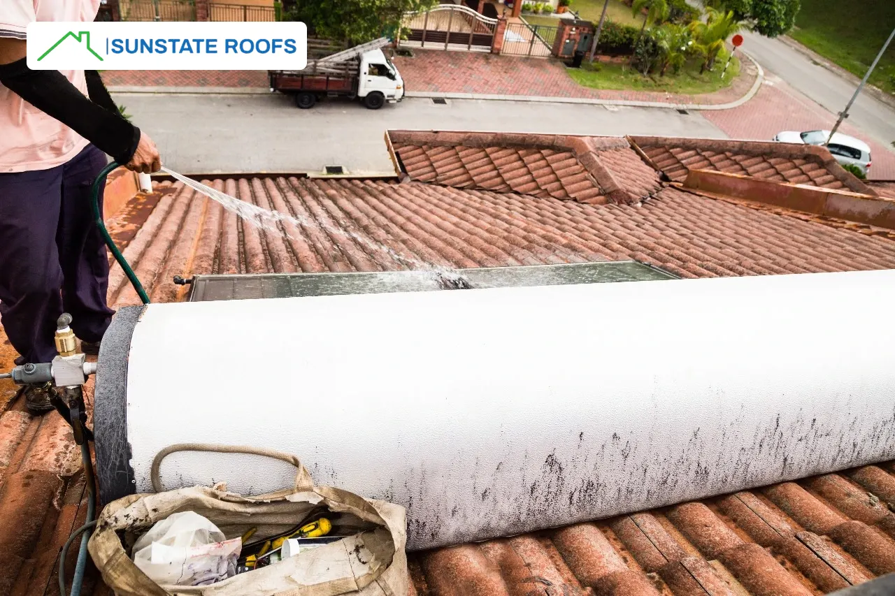 A professional applying a roof waterproofing membrane on a flat roof in Central Florida, showcasing effective waterproofing solutions like roof coatings and waterproofing products for concrete roofs. Ideal for roofing and waterproofing, the process highlights the use of advanced waterproofing membranes to protect homes in Florida's climate.