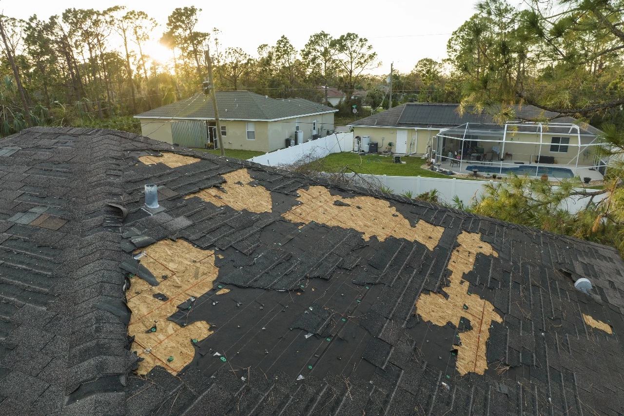 A damaged roof in Central Florida showing missing shingles and roof leaks. Highlighting roofing problems requiring roof maintenance and storm damage roof repair in Orlando. Sunstate Roofs Orlando, a trusted roofing contractor, offers expert repair solutions for such issues.

