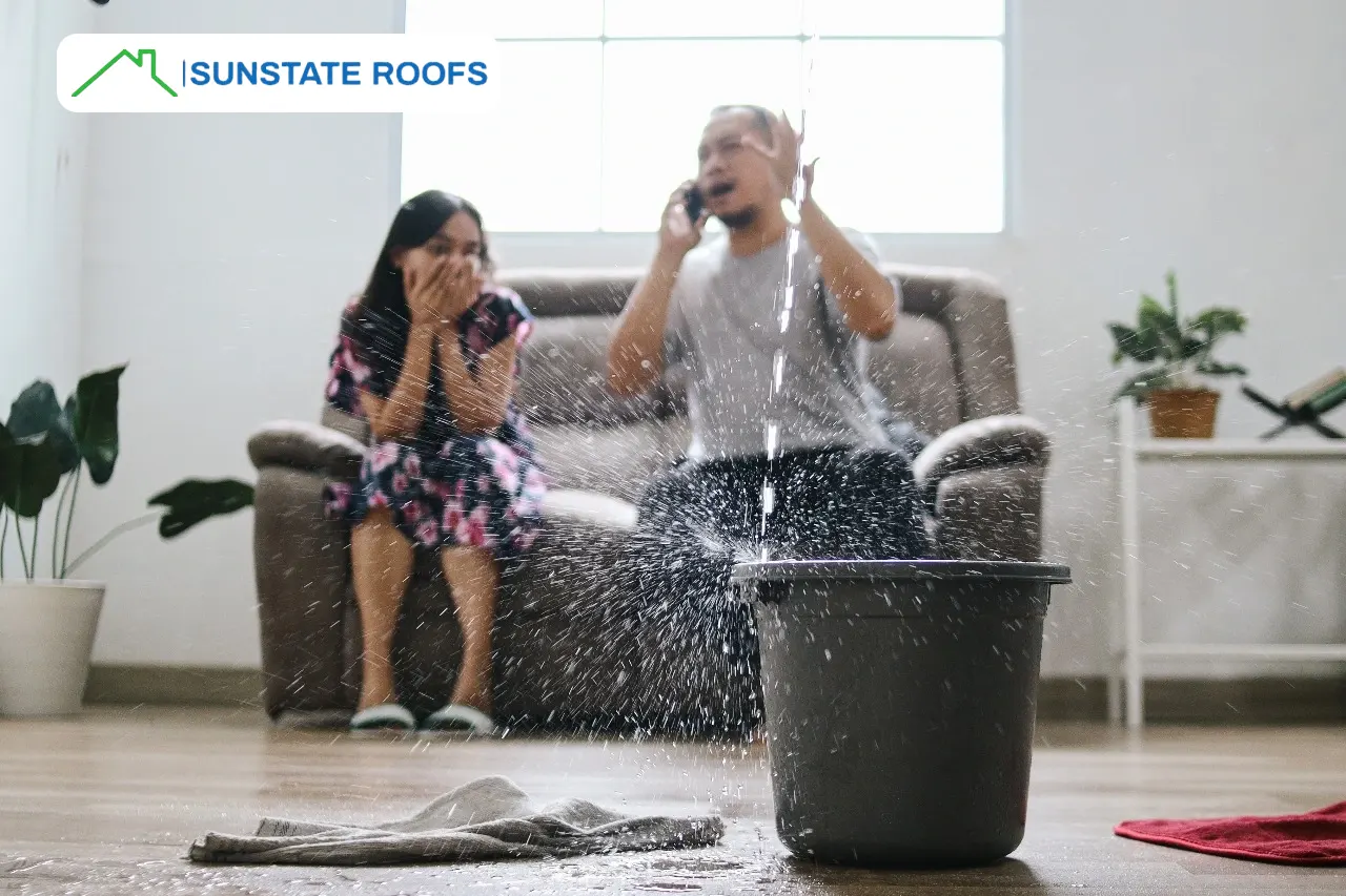 Concerned homeowners dealing with a leaking roof in Central Florida, highlighting the need for expert roof leak repairs, inspections, and solutions for residential roofs, including metal, flat, and tile roofs