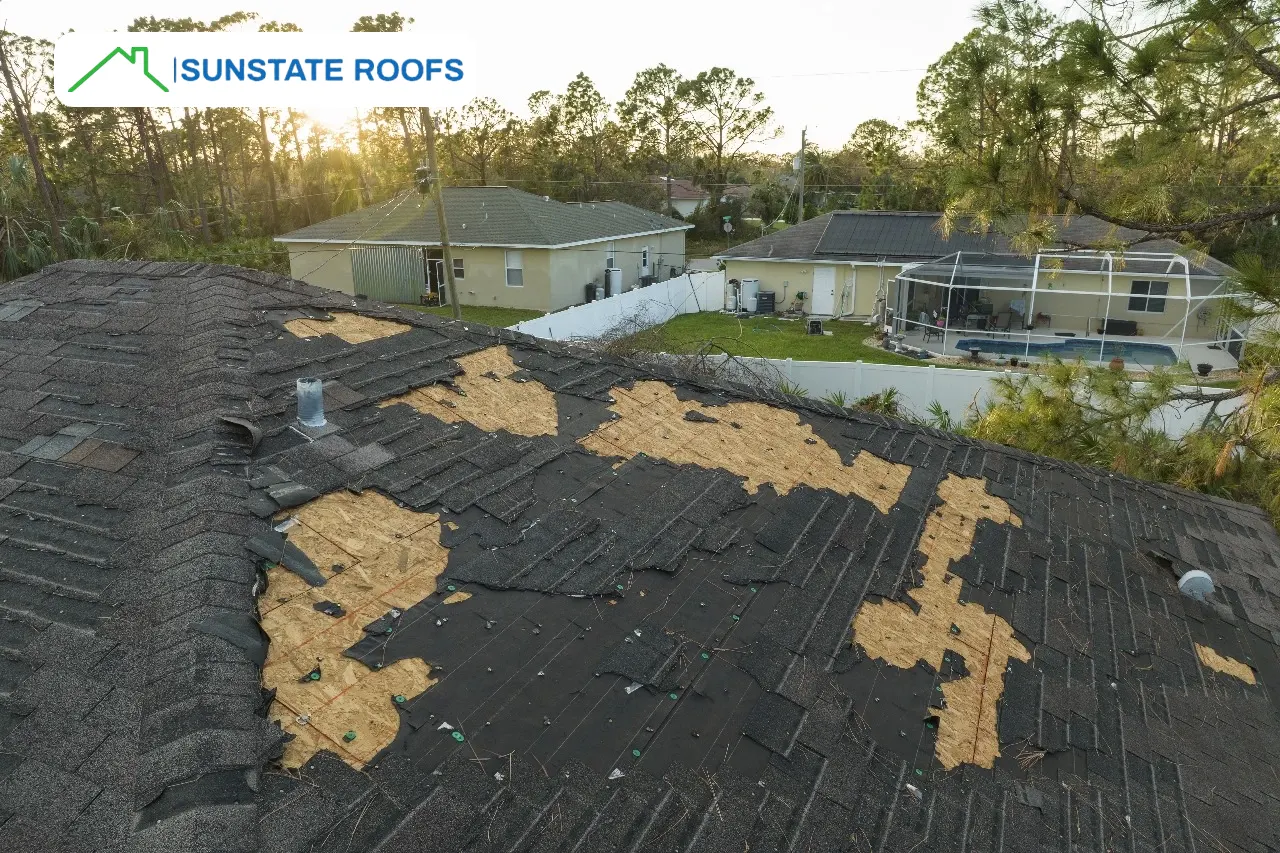 Residential roof in Central Florida with extensive shingle damage and exposed areas, emphasizing the need for roof leak repairs, expert roof inspections, and durable solutions for Florida roofs, including metal, flat, and tile roofing.