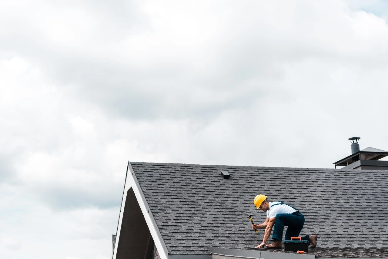 Roofing professional working on a residential roof in Central Florida, emphasizing roof maintenance, addressing Central Florida roofing challenges, routine inspections, leak detection, shingle replacements, and energy efficiency. Highlights Sunstate Roofs’ preventative maintenance plans, gutter cleaning, and services for protecting roof lifespan and ensuring durability.