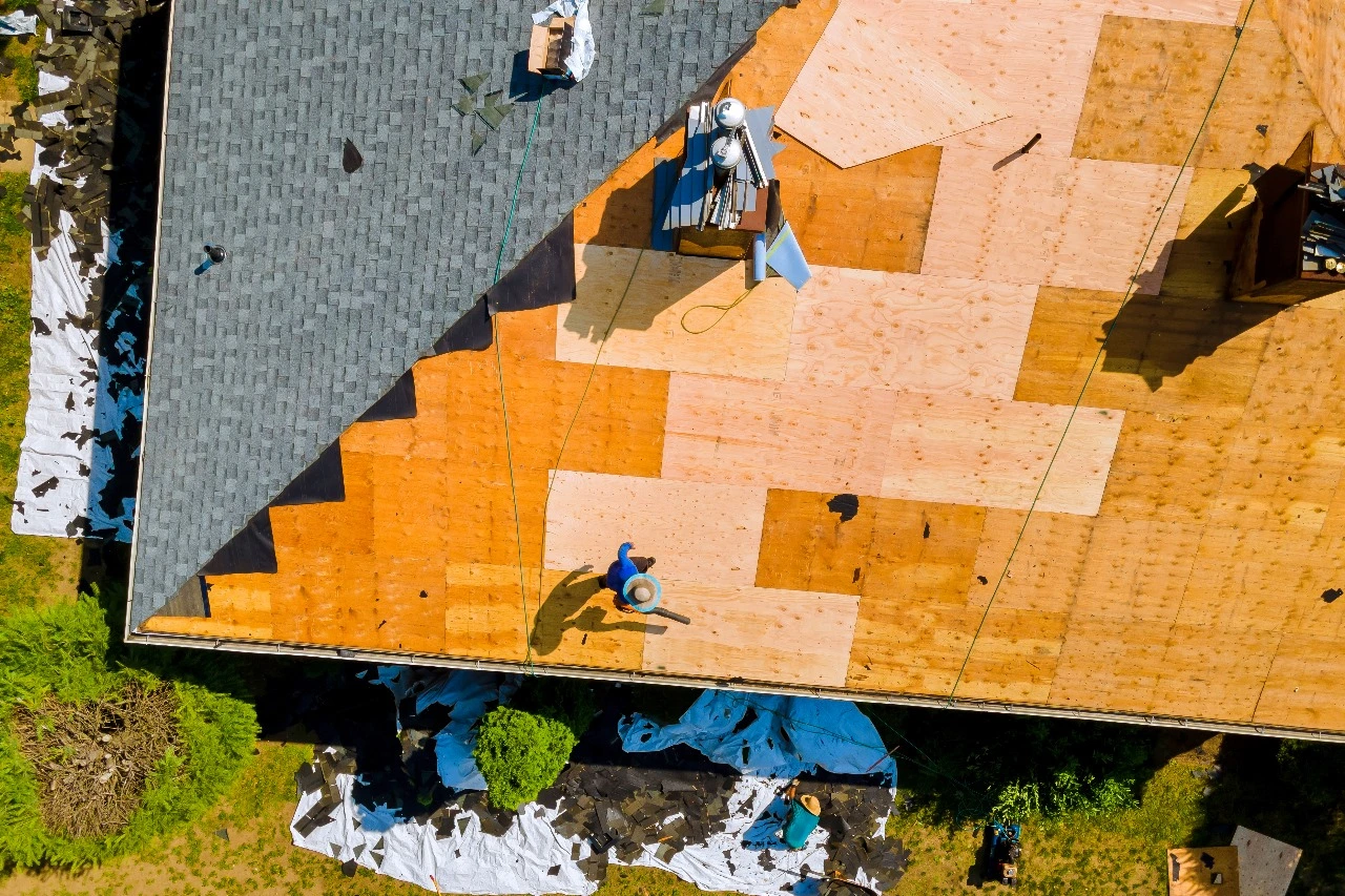 Overhead view of a roof replacement project in Central Florida, showcasing preparation of an existing roof for new shingle installation. Keywords: roof replacement, Central Florida, shingle roof, roof replacements, existing roof, roof repair, roof installation, metal roof replacement.