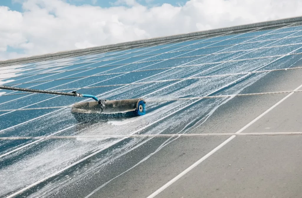 A professional worker cleaning a commercial flat roof using advanced techniques in Central Florida, showcasing Sunstate Roofs' roof cleaning services. For 'roof cleaning near central florida' or effective roof cleaning solutions, Sunstate Roofs ensures top-quality commercial service.