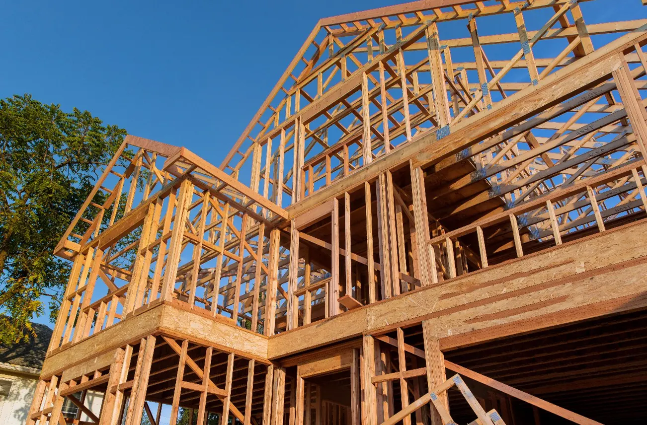 Wooden framework of a commercial building under construction in Central Florida, highlighting Sunstate Roofs' commercial service expertise. Specializing in commercial roof installation and industrial roof installation, Sunstate Roofs ensures compliance with Florida's building codes for safety and durability.