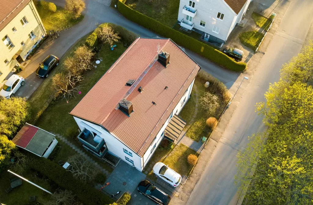 An aerial view of a clean, well-maintained residential roof in Central Florida, showcasing the benefits of Sunstate Roofs' professional roof cleaning services. Using advanced roof cleaning tools and eco-friendly solutions, their residential service is the top choice for 'roof cleaning near central florida' and 'roof cleaning services near central florida.