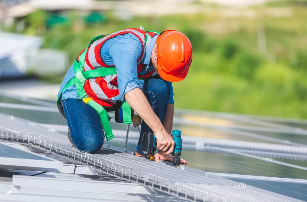 A roofing contractor performing commercial roof repairs on a large metal roof in Central Florida, representing Sunstate Roofs' expertise. Sunstate Roofs offers affordable commercial roof repair costs, trusted commercial roof repair contractors, and 'commercial roof repairs near me' services for businesses.