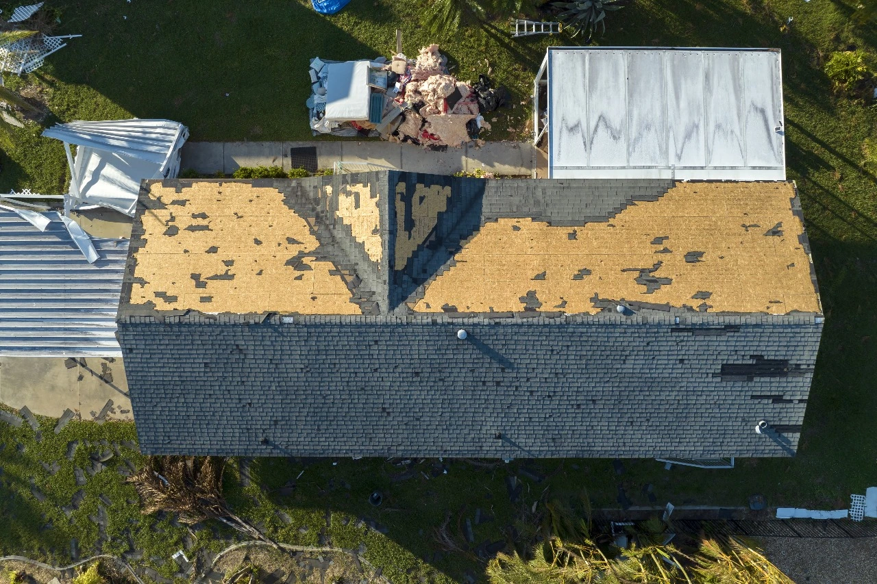 Overhead view of a damaged roof in Baldwin Park, FL, highlighting the need for professional roofing solutions such as roof inspections, repairs, replacements, and maintenance. Sunstate Roofs, a trusted roofing contractor in Baldwin Park, specializes in restoring roofs to optimal condition