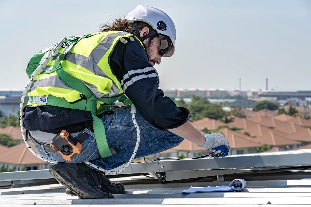 Roofing professional performing routine roof maintenance in Central Florida. Highlights include addressing Central Florida roofing challenges, professional roof inspections, leak detection, shingle replacements, gutter cleaning, and preventative maintenance for energy efficiency and roof lifespan protection.