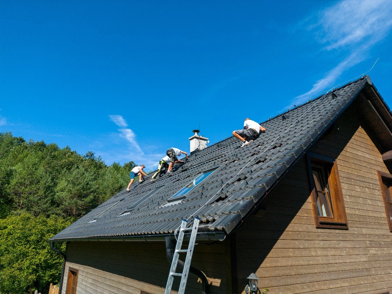 Roof replacement underway on a residential property in Central Florida, showcasing a team installing a durable shingle roof with preparations for metal roof replacement. Keywords: roof replacement, Central Florida, shingle roof, roof repair, roof installation, existing roof, metal roof replacement.