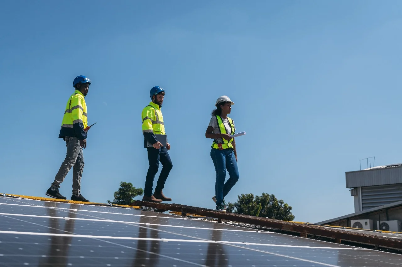 Construction team inspecting a roof in Central Florida to prepare for solar panel installation. Ensure seamless solar installation with a roof replacement before installing panels. Optimize energy efficiency and structural integrity for durable solar systems.