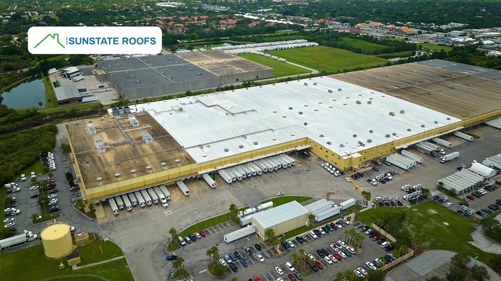 A large industrial warehouse showcasing an expansive commercial roofing system designed for energy efficiency and longevity. High-quality materials enhance durability and weather resistance.