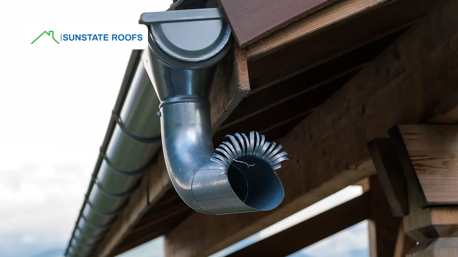 A damaged commercial gutter system in need of repair. Routine commercial roof maintenance is essential to prevent clogged gutters from causing water damage to the building