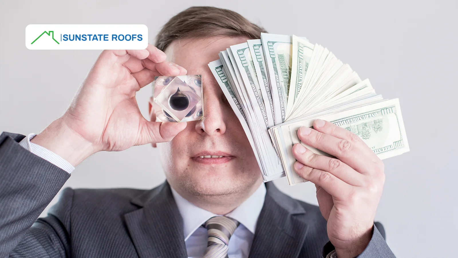 A businessman holding cash and a crystal to emphasize the financial impact of roof repairs, highlighting the importance of managing roof repair costs effectively.