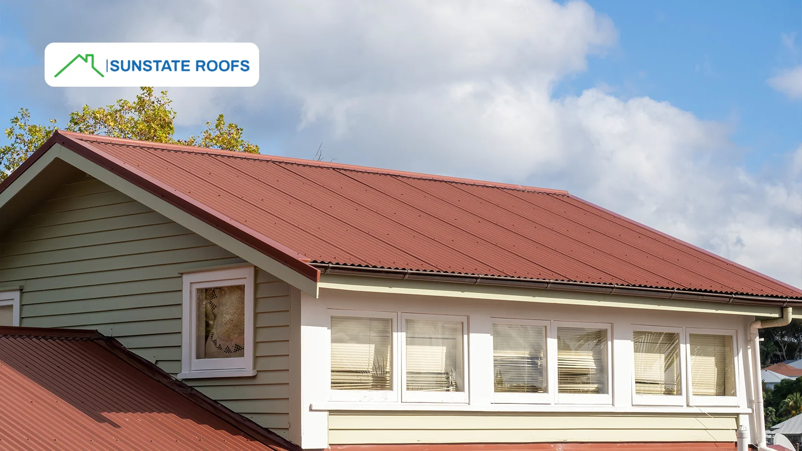 A house with a metal roof, showcasing a sleek, energy-efficient roofing solution provided by Sunstate Roofs. Metal roofs are a top choice for residential roof materials due to their durability and weather resistance.