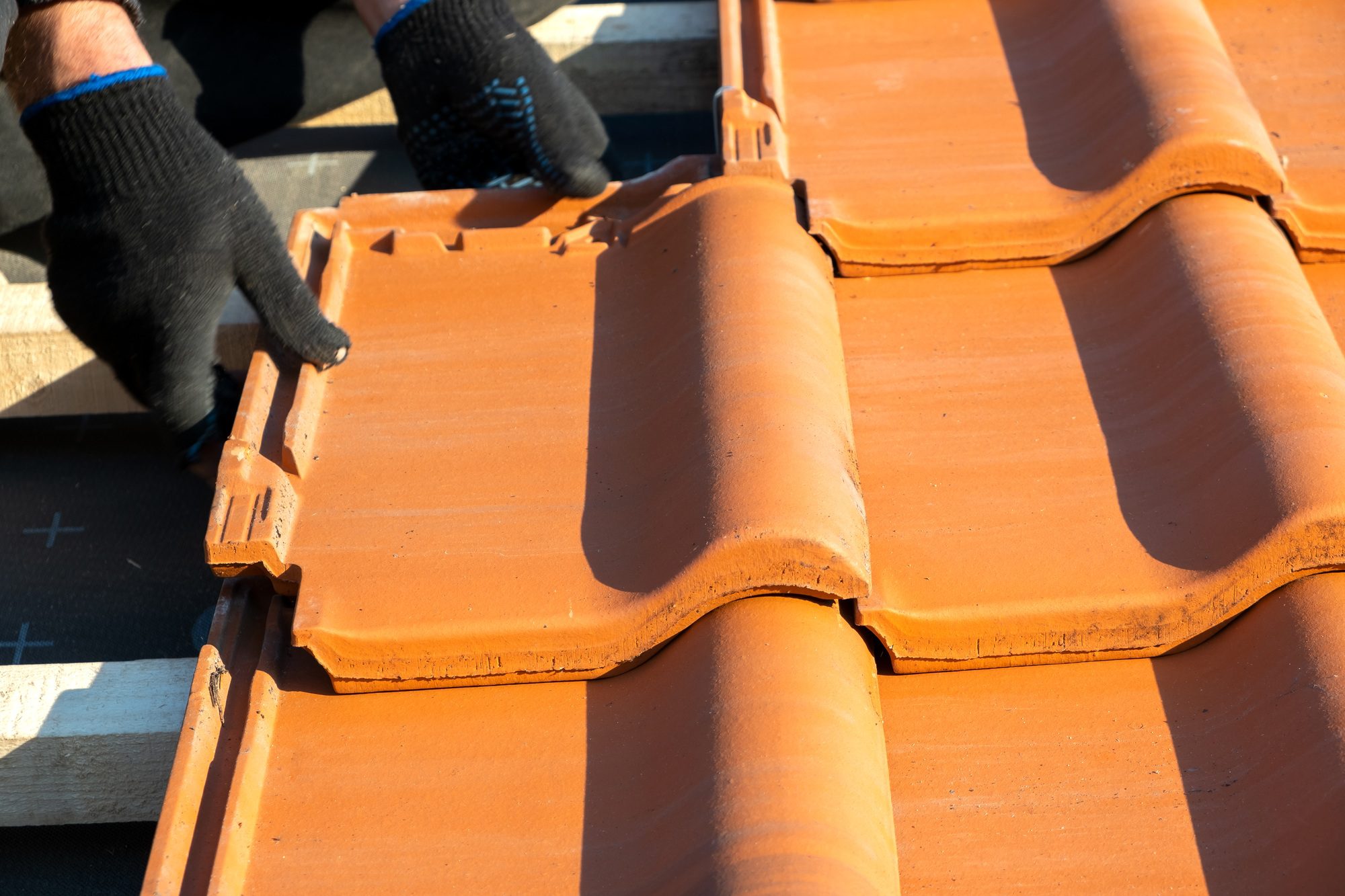Close-up of old, weathered ceramic roof tiles with visible damage and wear. Professional Roof Repair in Orlando can restore durability, prevent leaks, and extend the roof’s lifespan.