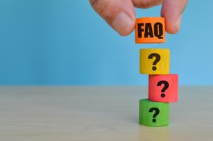 Colorful wooden cube blocks with text FAQ and question marks