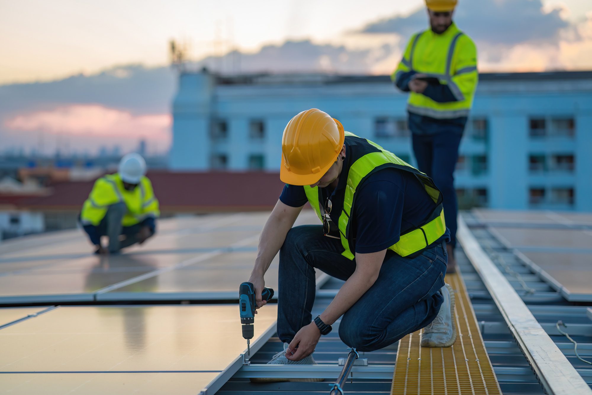 Engineer inspecting and installing solar cells on a factory roof – Expert Roofers Serving Oviedo ensuring quality and efficiency in solar roofing solutions.