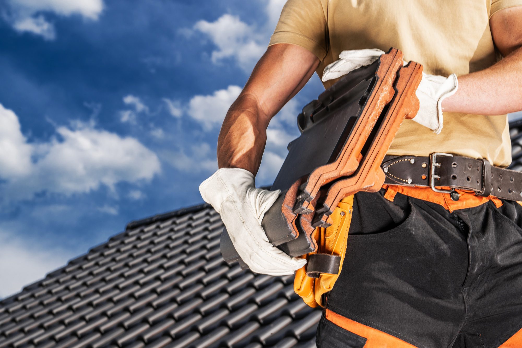 Roofing Contractor in Azalea Park: Expert Roofing Worker Moving Black Roof Ceramic Tiles