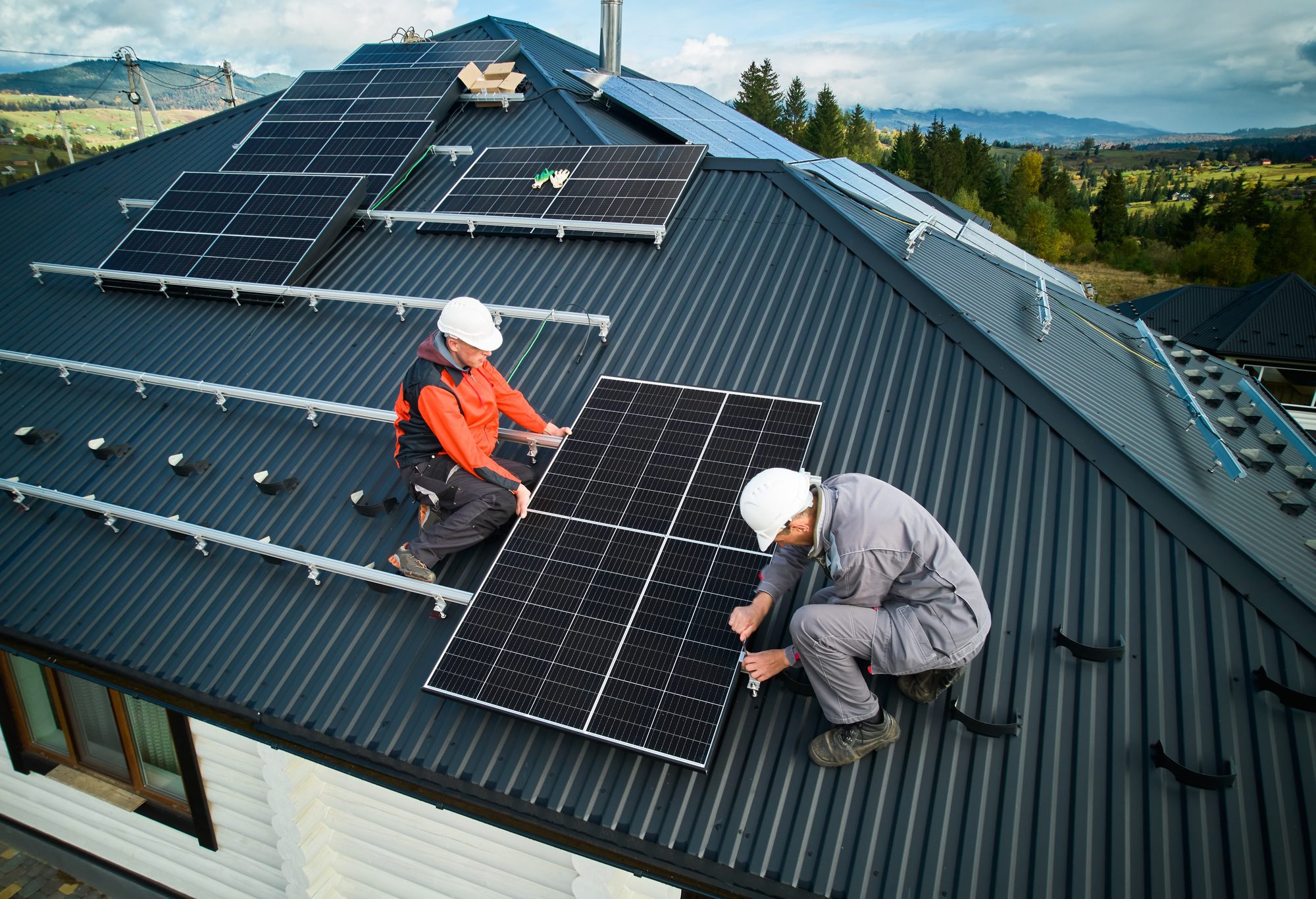Technicians from a Roofing Company in Casselberry expertly installing photovoltaic solar panels on a residential roof, ensuring energy efficiency and sustainable roofing solutions.