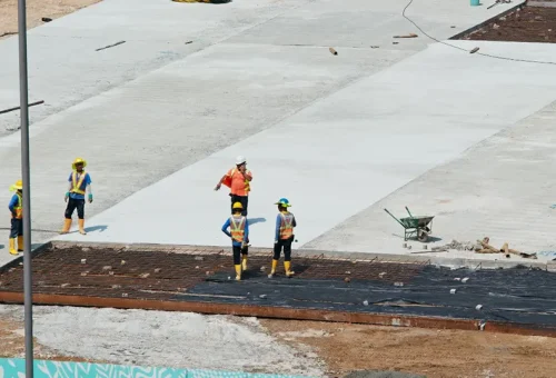 A team of professional roofing contractors from a Central Florida roofing company providing waterproofing services on a large surface, ensuring long-lasting protection for residential roofing and other structures