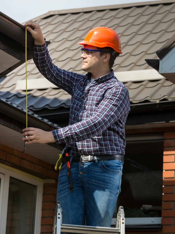 Luke Colman, founder of Sunstate Roofs, a leading Central Florida roofing company, measuring a roof during an inspection. Sunstate Roofs’ professional team specializes in residential roofing and commercial roofing solutions with expert craftsmanship